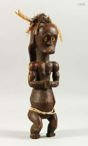 A CARVED WOOD TRIBAL FIGURE, of a standing male, hands