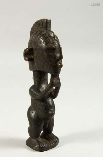 A SMALL CARVED WOOD TRIBAL FIGURE of a man with his