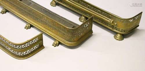 THREE 19TH CENTURY PIERCED BRASS FENDERS.  108cms long,