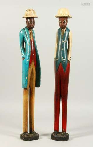 A PAIR OF TALL, THIN, CARVED AND PAINTED WOOD MALE