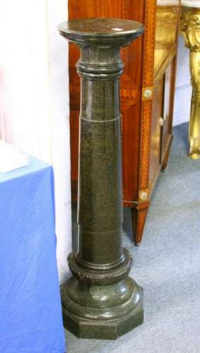 A SERPENTINE COLUMN, with a circular top and column, on