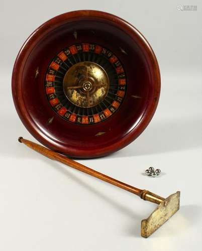 A TABLE TOP ROULETTE WHEEL, with accessories.  26cms