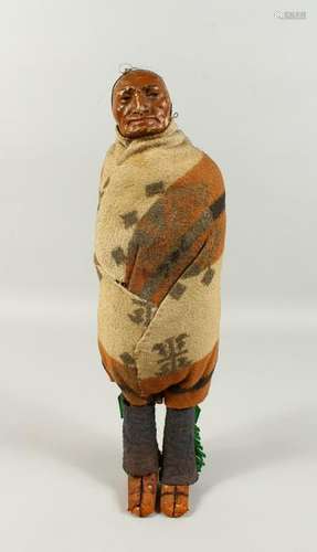 A RESERVATION INDIAN DOLL, painted plaster head.  43cms