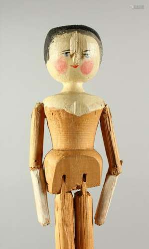 A CARVED PINE FOLK ART DOLL.  29cms high.