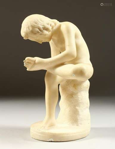 A CARVED ALABASTER GROUP, young boy removing a thorn