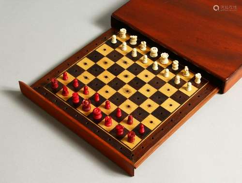 A MAHOGANY CASED TRAVELLING CHESS SET.  20cms wide.