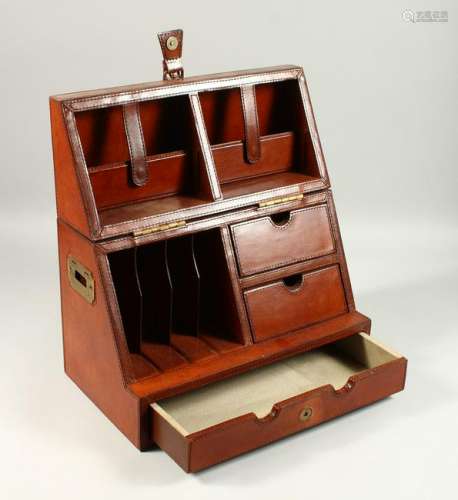 A LEATHER STATIONERY BOX. with folding top drawers and