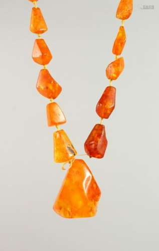 AN AMBER NECKLACE, comprising one large central