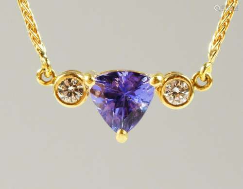 AN 18CT GOLD, SAPPHIRE AND DIAMOND PENDANT on a chain.