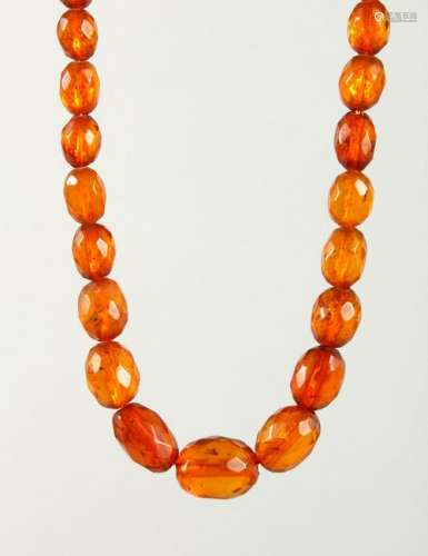 A SET OF FACETED AMBER BEADS.  Largest: 18mm long.
