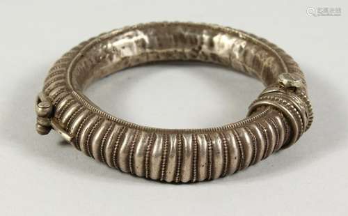 AN INDIAN SILVER BANGLE.  9cms diameter.