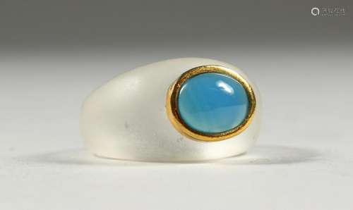 AN UNUSUAL CRYSTAL RING, inset with a blue stone.