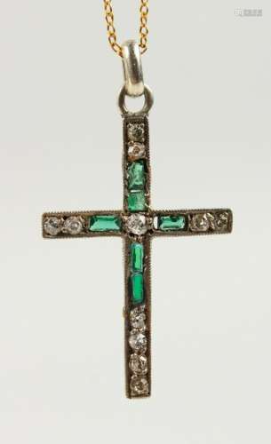 AN 18CT GOLD, DIAMOND AND EMERALD CROSS on a chain.