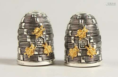 A PAIR OF .800 SILVER BEEHIVE SALT AND PEPPERS.