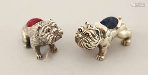 TWO CAST SILVER BULLDOG PIN CUSHIONS.