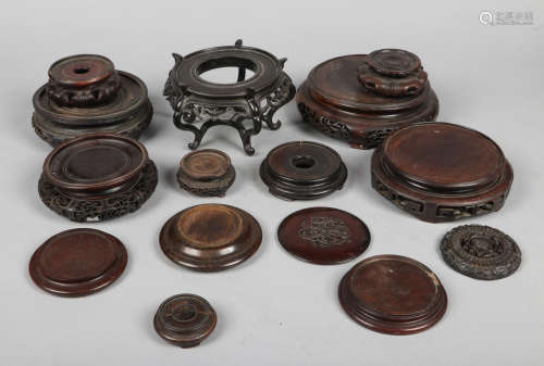 Thirteen Chinese carved hardwood ornament stands including 19th century examples along with two