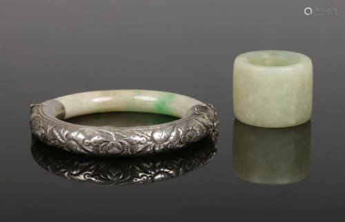 A Chinese silver mounted jadeite bangle chased with flowers along with a celadon jade archers