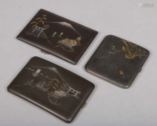 Three Japanese Komai cigarette cases. Two decorated with a landscape with Mount Fuji, the other with