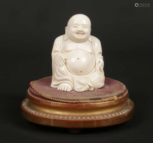A 19th century Chinese carved ivory figure of a seated Buddha raised on an associated French