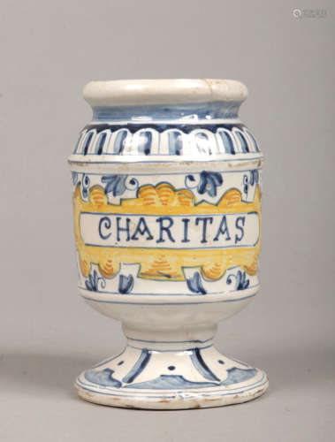 An early 19th century Continental polychrome delft drug jar or albarelli. Painted blue and yellow