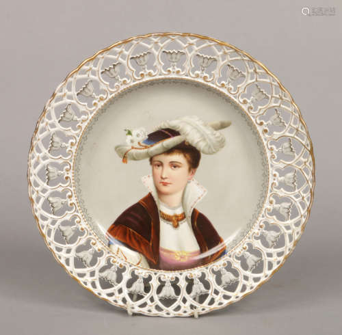 An early 20th century Continental porcelain dish with pierced border. Painted to the centre with the