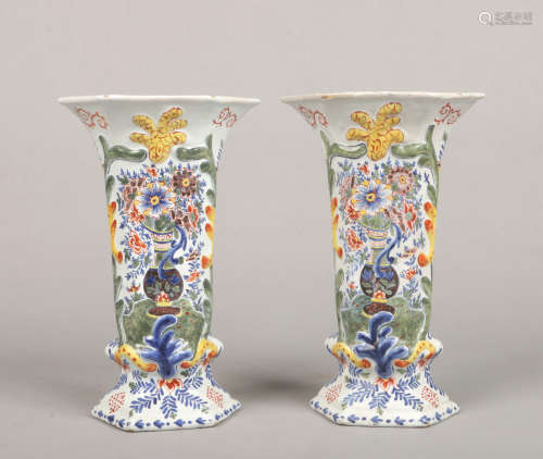 A pair of 19th century Dutch Delft polychrome vases of flattened hexagonal form. Each moulded with