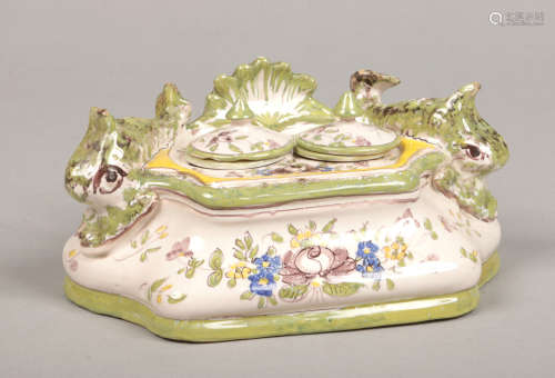 A 19th century Continental polychrome faience desk stand incorporating a pair of inkwells and with a