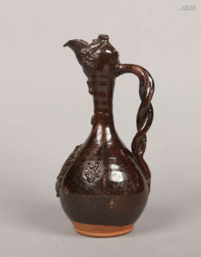 A 19th century Turkish Canakkale pottery ewer. Decorated in a brown glaze and with sprigged