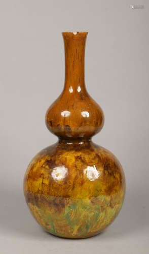 A large Victorian Art pottery vase of double gourd form. Decorated in green, yellow and brown glazes