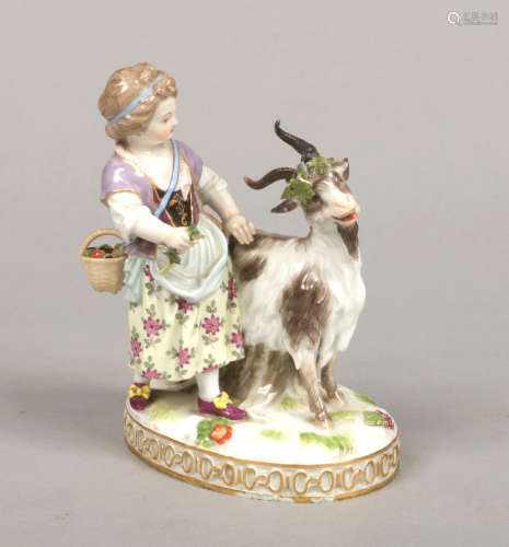 A 19th century Meissen figure of a girl herding a goat. Decorated in coloured enamels and raised