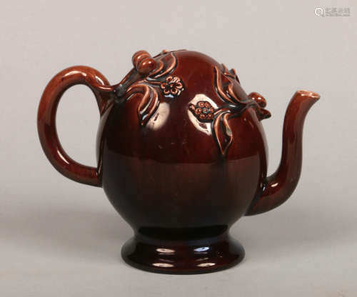 A Brameld treacle glazed Cadogan pedestal teapot. Moulded with leaves and berries. Impressed mark