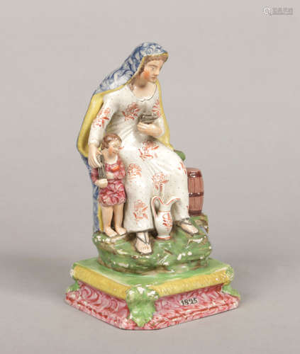 A Staffordshire pearlware figure, the Widow. Decorated in coloured glazed and raised on an ogee