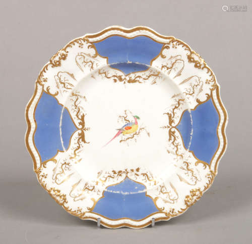 A Rockingham plate with bead moulded lobed rim. Having Brunswick blue and gilt border and painted to