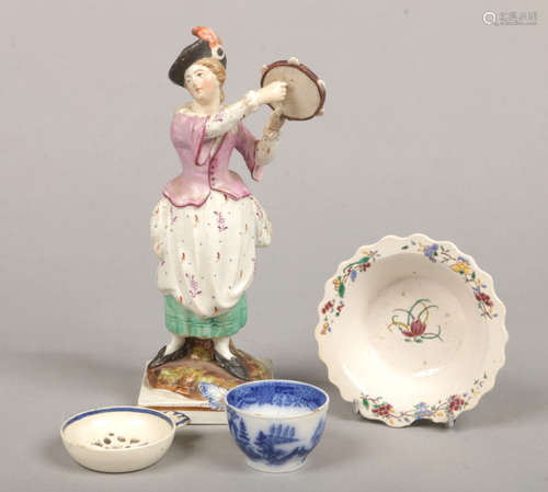 An early 19th century Staffordshire pearlware figure of a girl playing a tambourine, a saltglaze