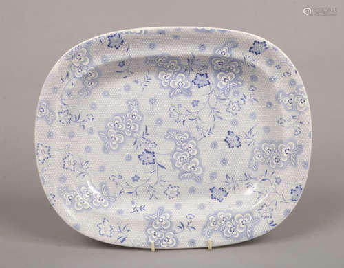 A Twigg Newhill pottery blue and white meatplate. Decorated with flower sprigs over a cell ground.