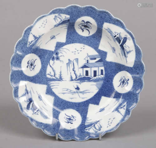 An unusual Caughley scalloped blue and white plate. Powder blue ground and painted in underglaze