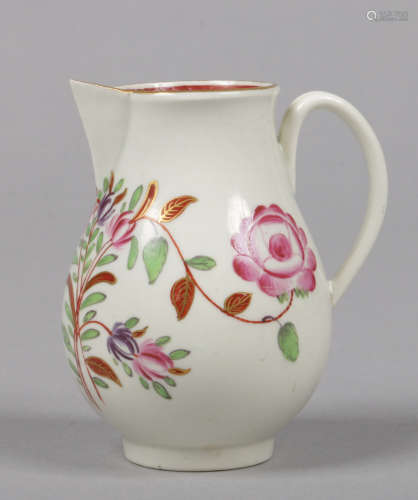 A Worcester sparrow beak jug with grooved loop handle. Painted in coloured enamels with flowers in