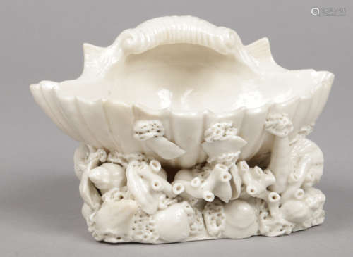 A Plymouth white glazed shell formed salt seller. Raised on a triform coral moulded base applied