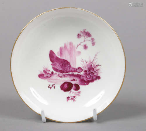 A Meissen Marcolini saucer. With gilt rim and painted puce camaieu with a chicken in a landscape.