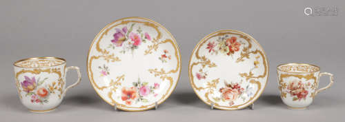 A 19th century Berlin teacup and saucer and coffee cup and saucer. With raised gilding and painted