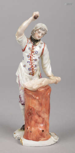 A rare Ludwigsburg figure of a butcher chopping meat. Decorated in coloured enamels and raised on