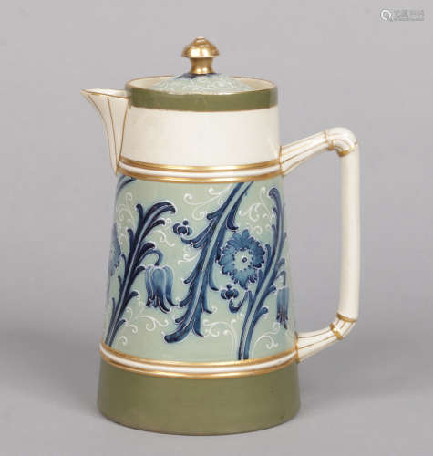 A James Macintyre & Co. hot water jug and cover designed by William Moorcroft. With green and gilt