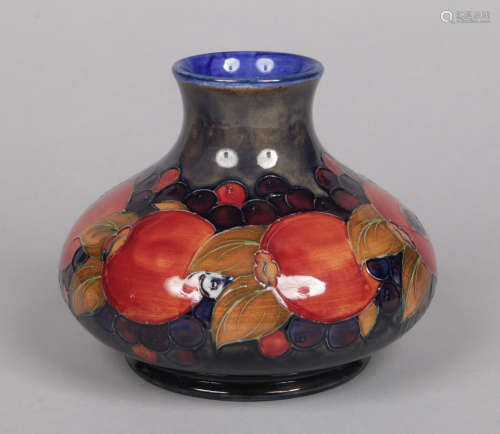 A large Walter Moorcroft onion shaped vase. Ground in cobalt blue glaze and decorated in the