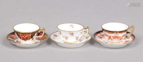 Three early 20th century Royal Crown Derby miniature teacups and saucers. Including a Kings