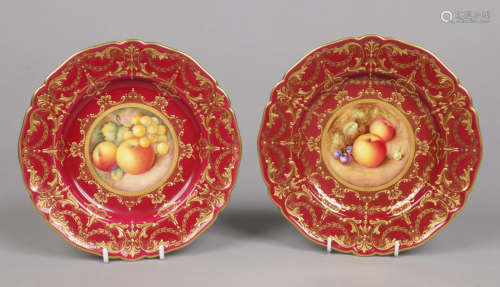 A pair of Royal Worcester scalloped cabinet plates. Claret ground, with raised gilding and each