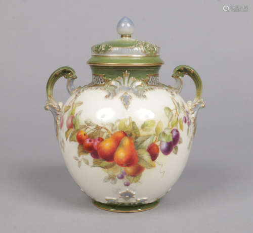 A Royal Worcester twin handled potpourri jar and cover. With pierced collar, moulded with scroll