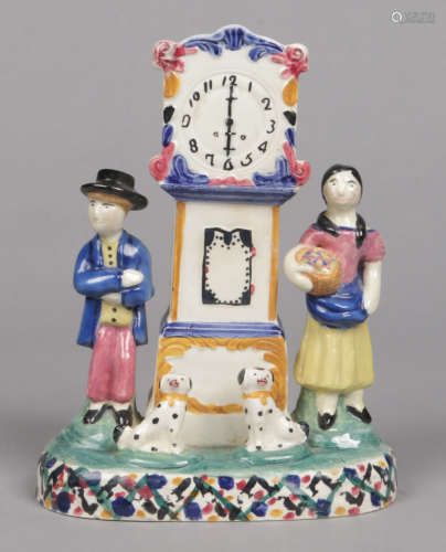 A 19th century prattware money box, Mexborough, Yorkshire. Formed as a longcase clock flanked by a