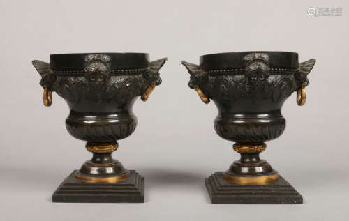 A pair of 19th century Continental bronze urns in Neo-Classical style. With gilt embellishments