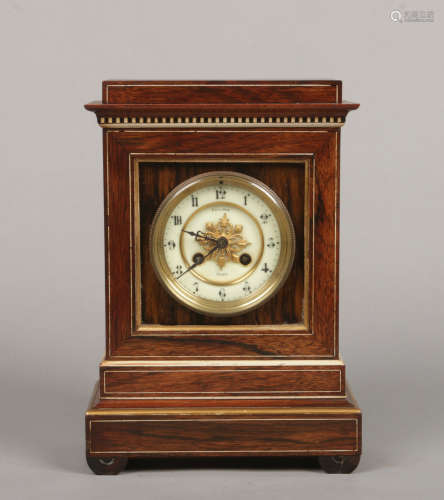 A 19th century French rosewood and parcel gilt cased mantel clock. With strung inlay, having