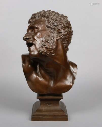 A 19th century patinated bronze bust of oversize proportions. Modelled in the Greek style as a man